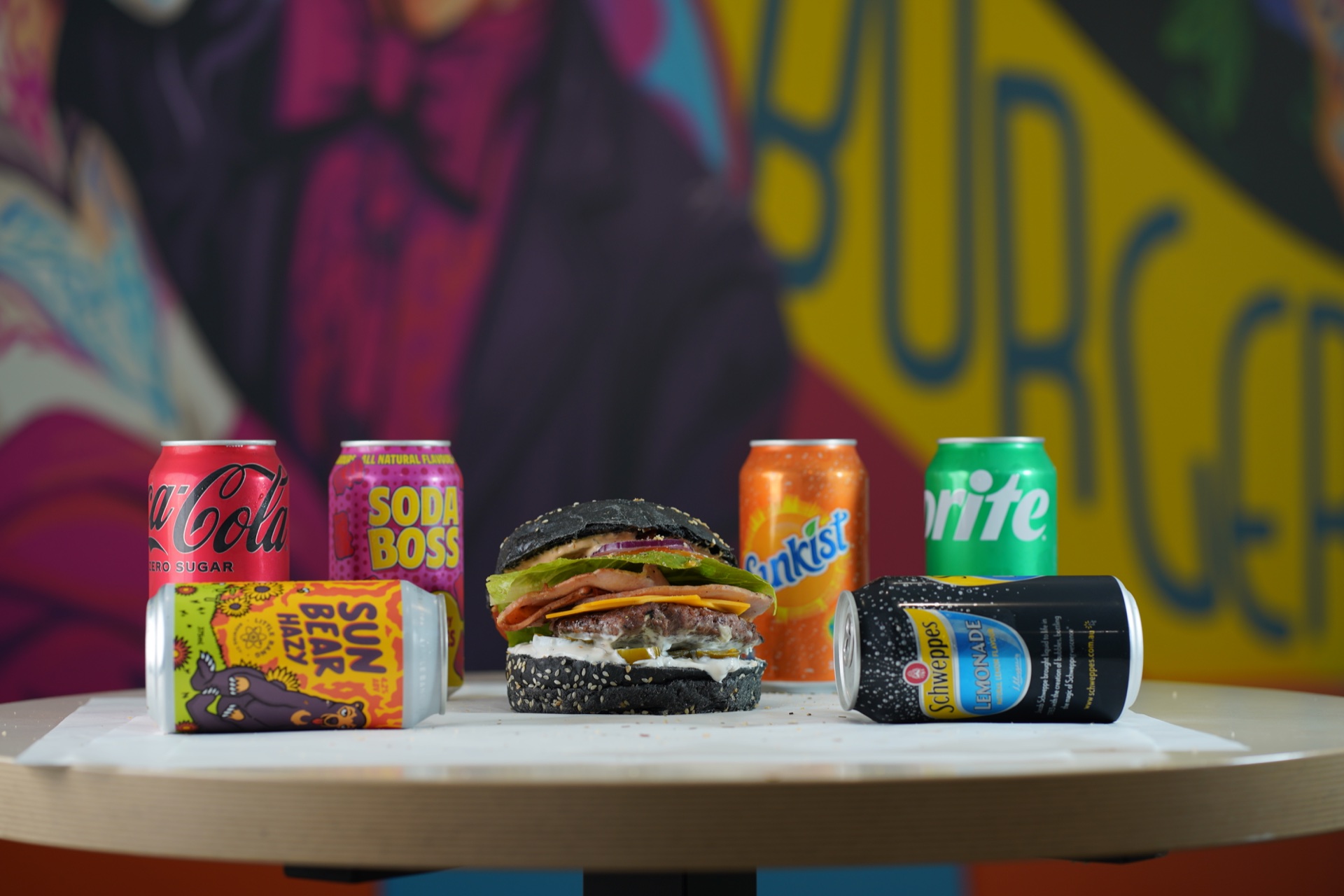 El Burgerritos black bun burger with a colourful drinks selection